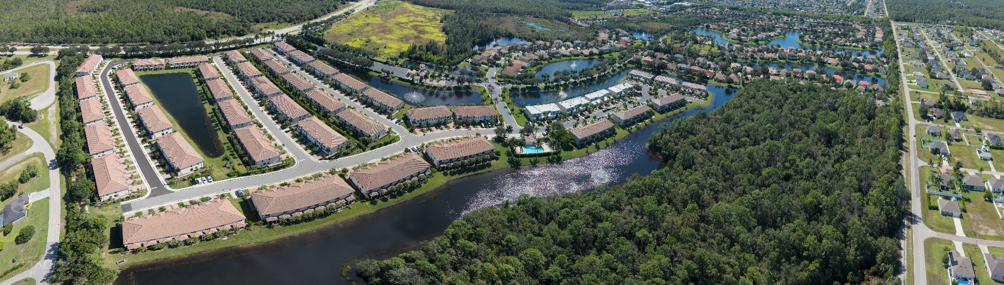 Stitched aerial panorama of the Coral Lakes residential community and surrounding landscape